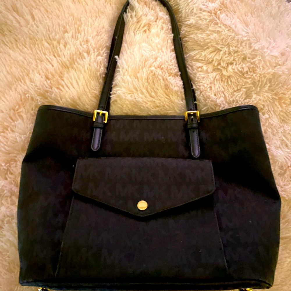 Woman’s Michael Kors black signature handbag